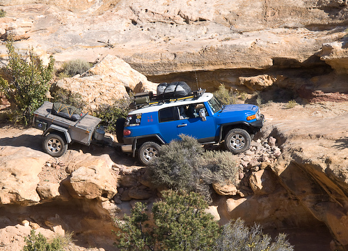 The road follows a ledge around the head of the canyon